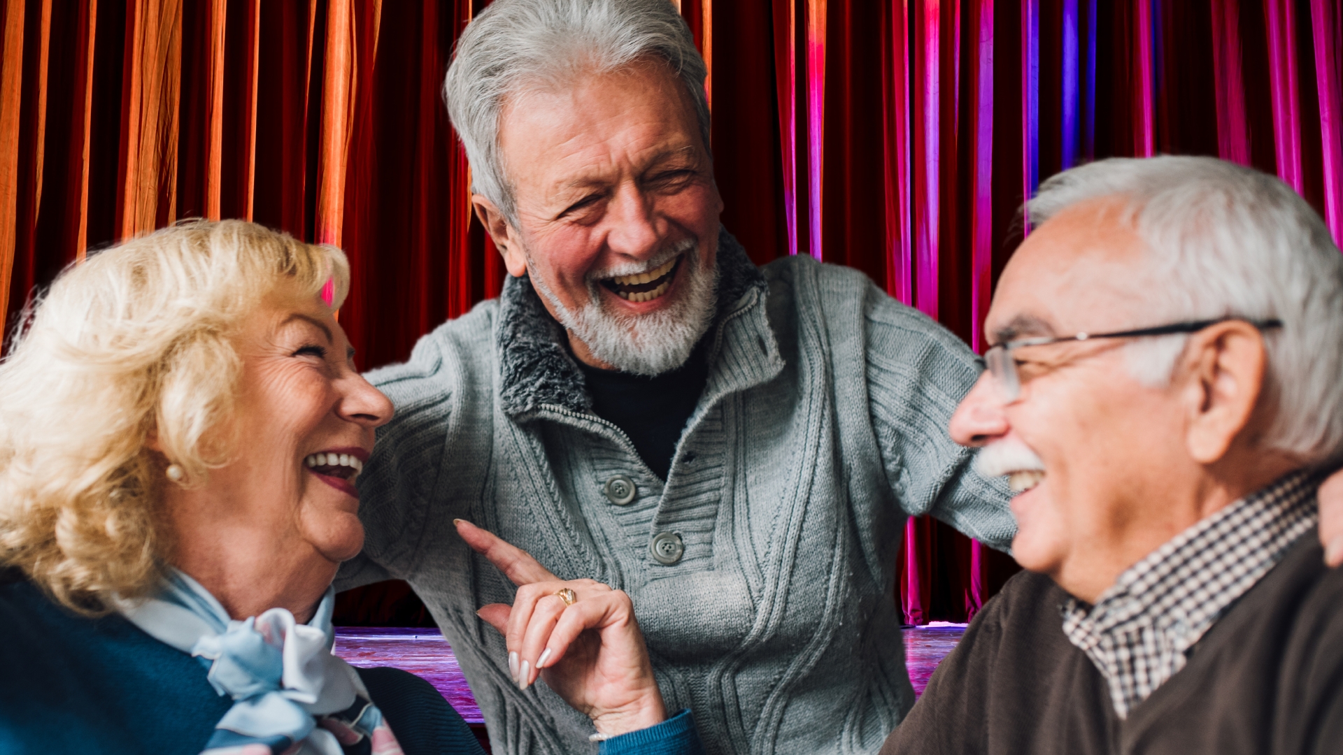 A group of three volunteers laugh at a shared joke. 